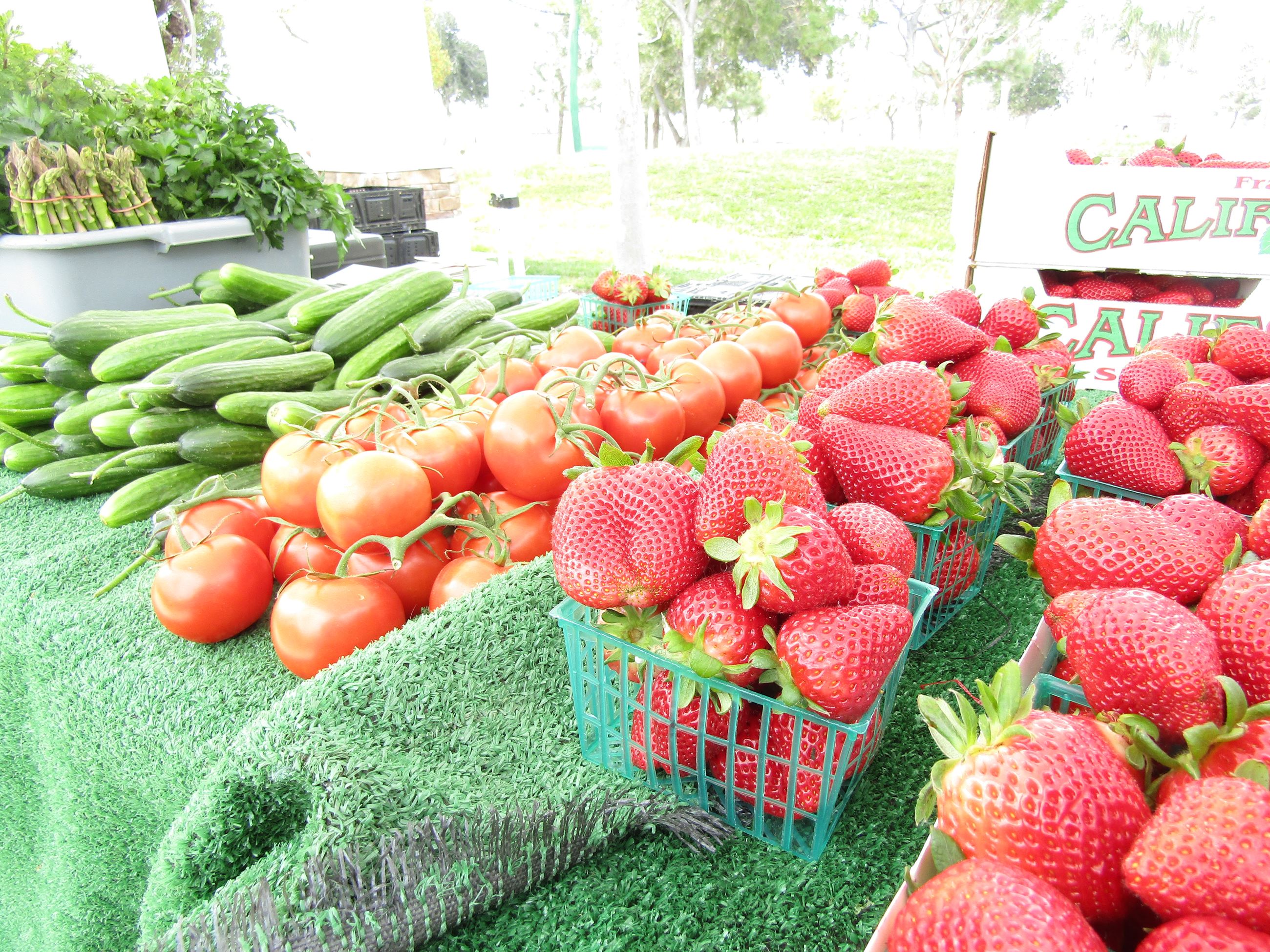 Fresh produce, cucumbers, tomatoes, strawberries, at the Farmers' Market